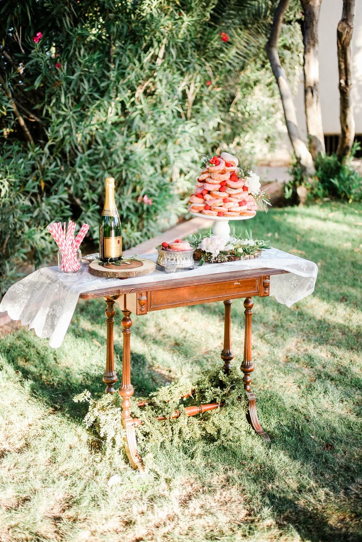 Wedding Table with Bottle of Wine and Pastries Outdoors